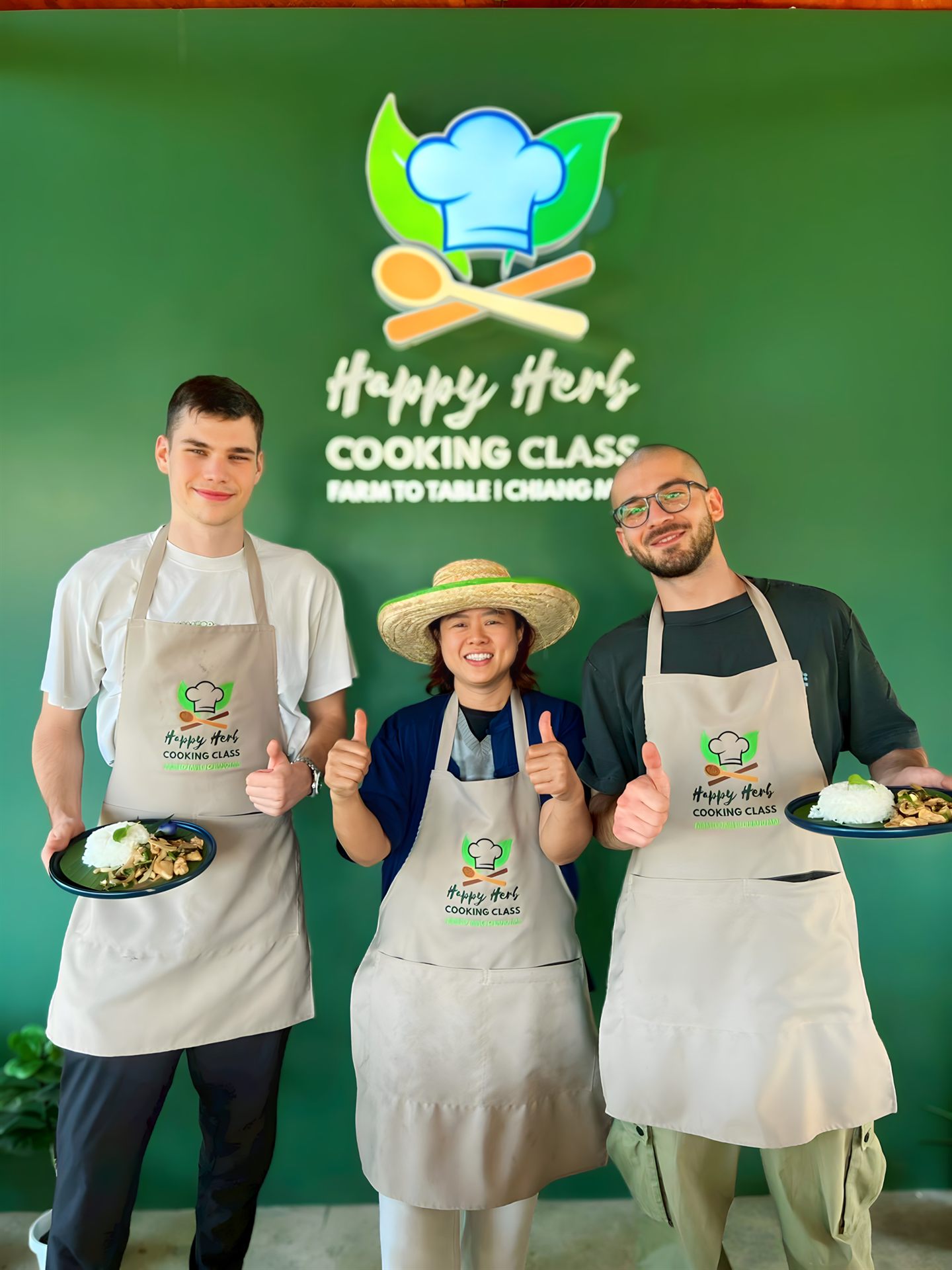 Happy group photo of travelers at the Happy Herb Cooking Class in Chiang Mai