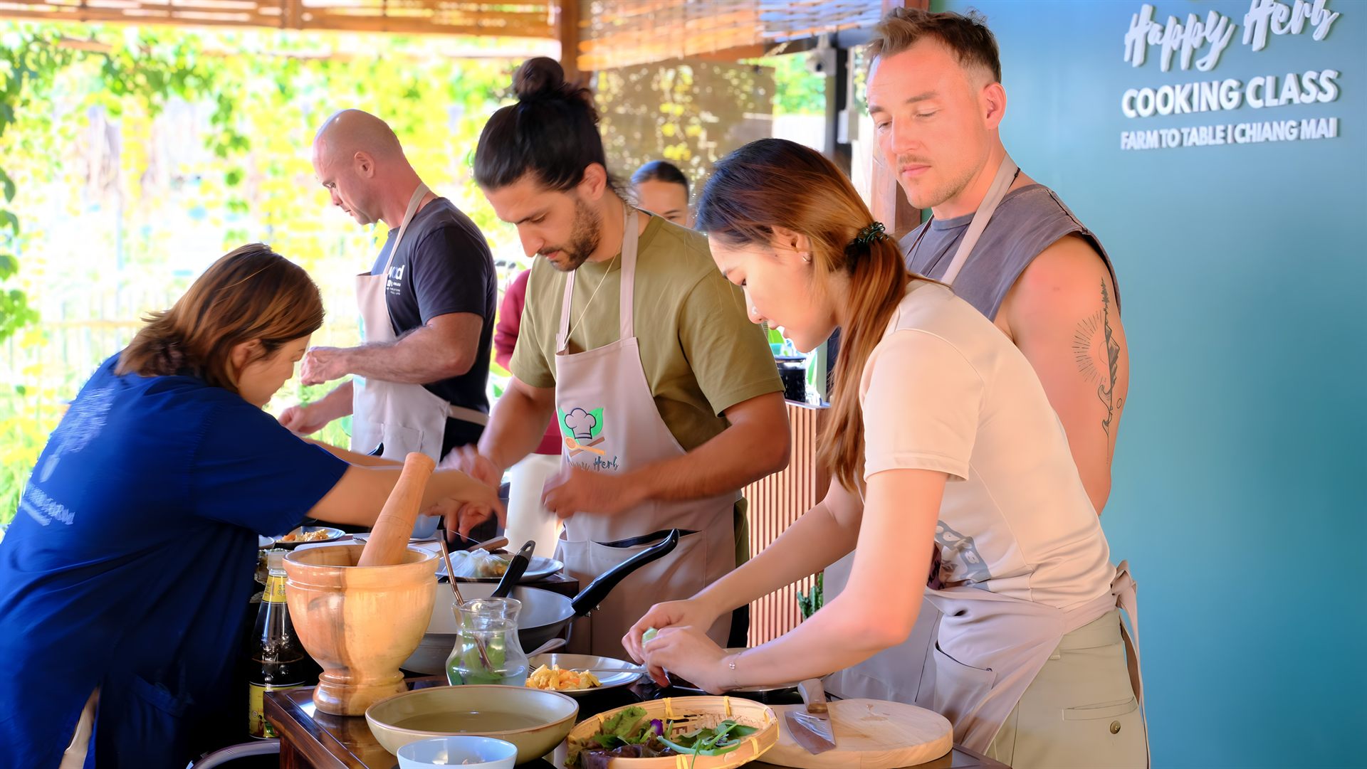 Guests preparing fresh Thai ingredients during the Happy Herb Cooking Class